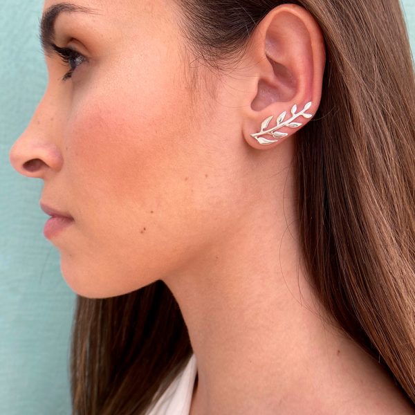 Pendientes trepadores con forma de ramita con hojas intercaladas por ambos lados, diseñado con curva que sigue la forma del lóbulo, quedando este perfectamente integrado en la oreja.